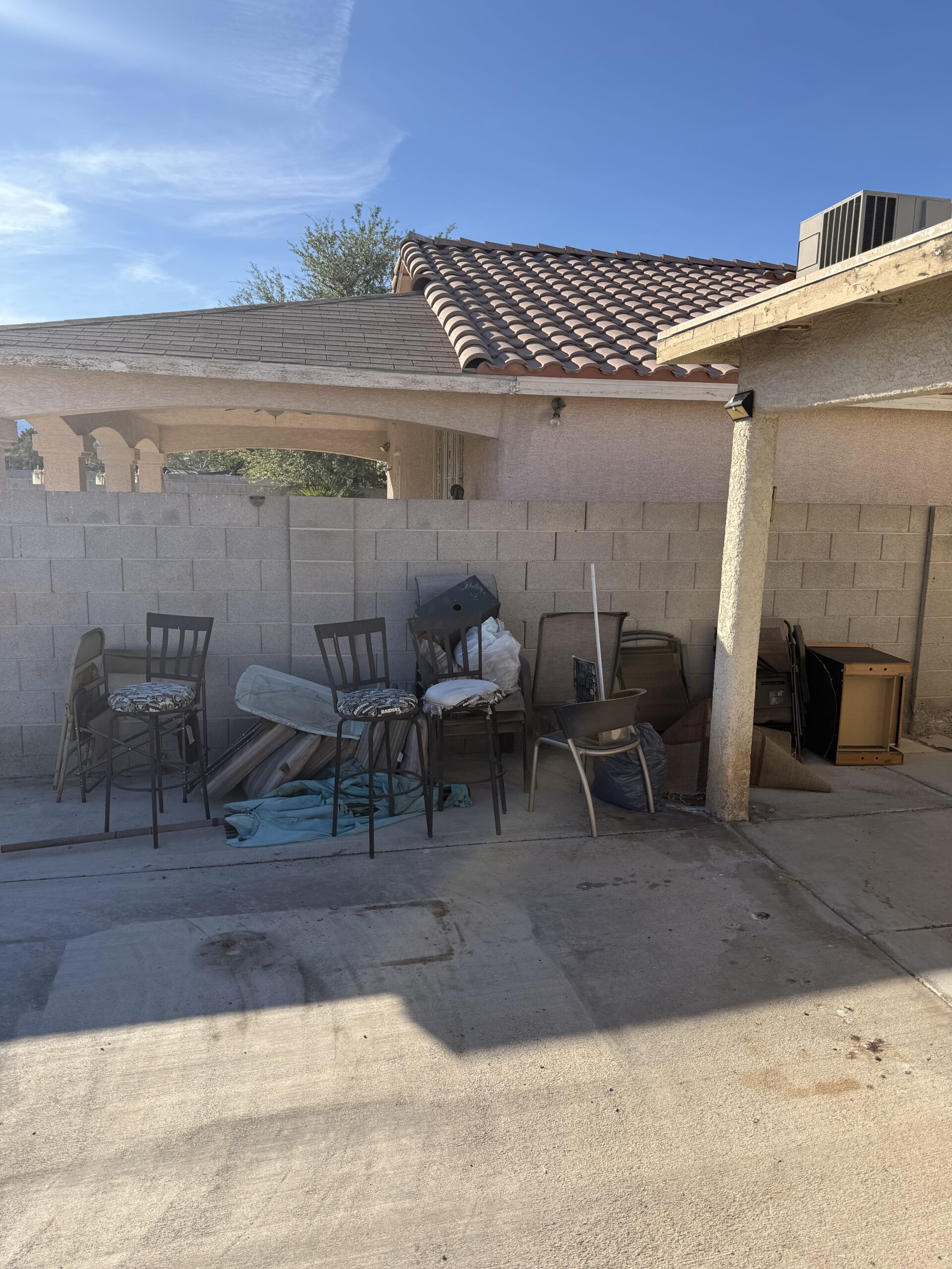 Before: Cluttered backyard needing yard debris and trash removal in Henderson Nevada